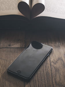 space gray iPhone 6 turned off on brown wooden table thumbnail