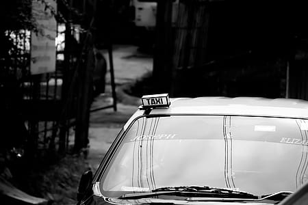 Grayscale Photography of Taxi on Road thumbnail
