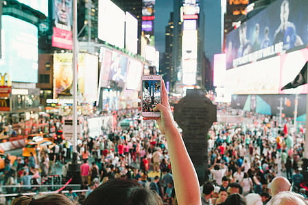 person taking photo of group of people thumbnail