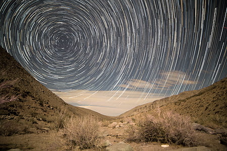 time lapse photography sky between mountains thumbnail