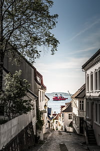 photo of red ship on body of water thumbnail
