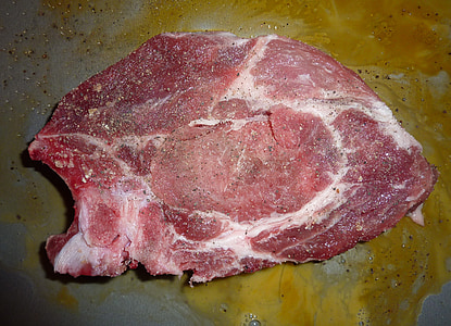 raw meat slice placed on yellow surface thumbnail