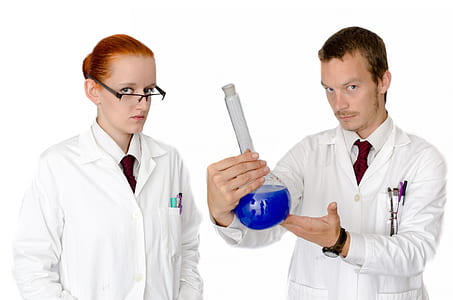 man holding clear glass with liquid thumbnail