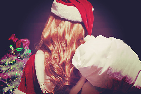 closeup of woman wearing santa suit holding bag thumbnail