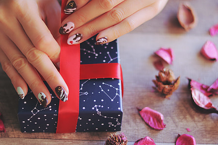 person holding blue constellations printed gift box thumbnail