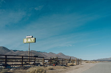 Eat signage beside fence thumbnail