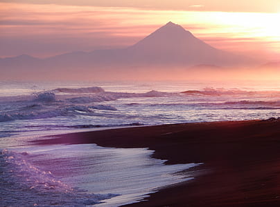 sea of water near mountain during sunrise thumbnail