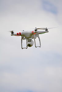 white quadcopter drone in mid air thumbnail