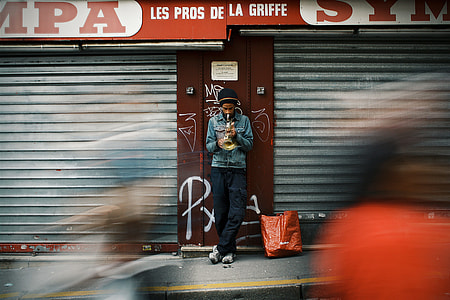 man laying on gray and maroon door shutter thumbnail