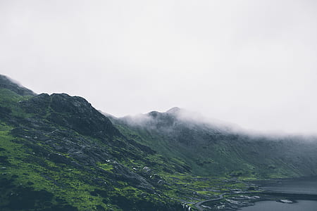 scenery of green mountains under cloudy sky thumbnail