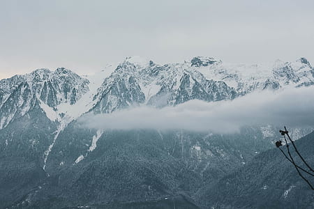 in distant photo of mountain cape by snow thumbnail