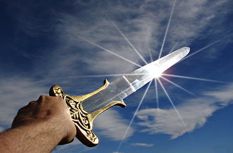 person holding silver and gold sword thumbnail