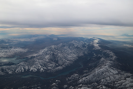 aerial photography of river between mountains under cloudy sky thumbnail