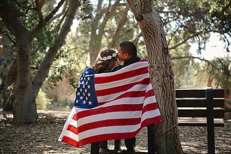 man and woman holding flag of USA thumbnail