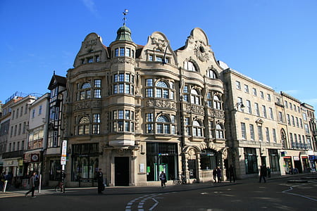 people walking beside buildings during daytime thumbnail