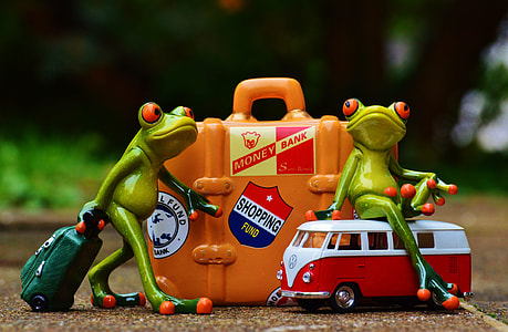 two green frogs sitting on bus and holding luggage figures thumbnail