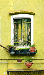 white and black wooden window on yellow concrete wall thumbnail