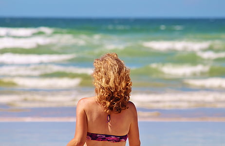 woman facing ocean at daytime thumbnail