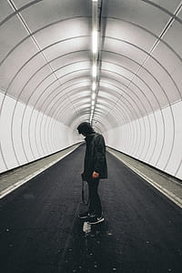 Man in Black Hoodie Standing Inside Panel thumbnail