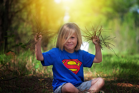 shallow focus photography of boy in blue Superman shirt thumbnail