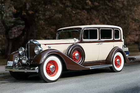 vintage white and brown car on road thumbnail
