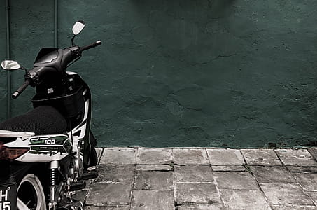 Black and White Ct 100 Motorcycle Parked Near Concrete Wall thumbnail