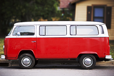red and white bus beside brown house thumbnail