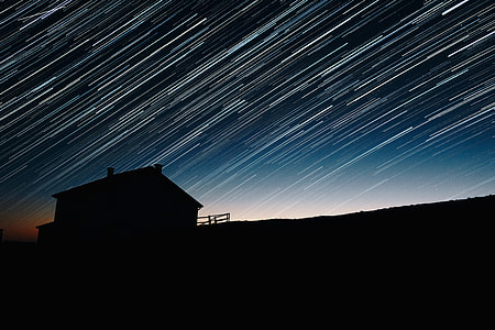 Star Trails and house silhouette at night astrophotography thumbnail