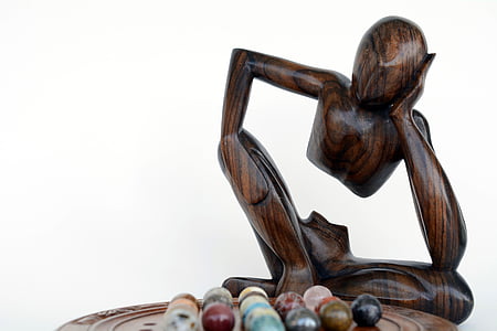 brown human statue near on marble ball toy collection thumbnail