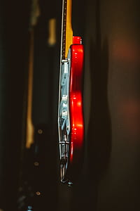 shallow focus photography of red and white electric guitar thumbnail