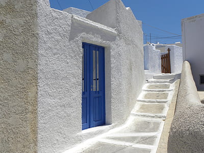 blue wooden door near staircase thumbnail
