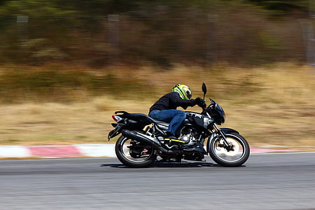 man riding motorcycle on gray road thumbnail