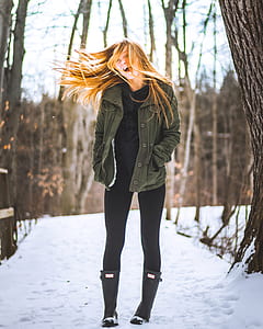 woman wearing jacket standing on pathway thumbnail