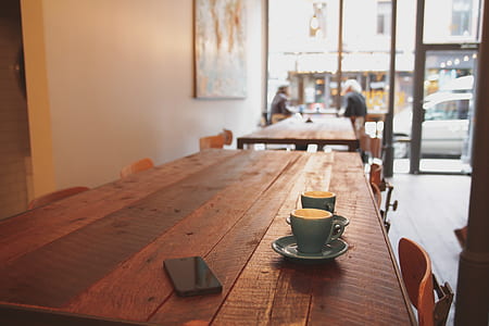 two gray ceramic teacup on brown wooden table thumbnail