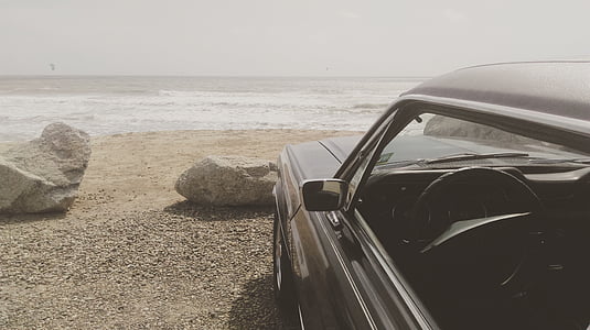 vehicle parked near rock and ocean thumbnail