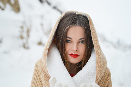 woman wearing brown and white coat with snow particles on her head focus photography thumbnail