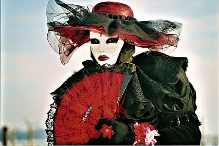 woman in black dress with red hand fan and red sun hat thumbnail