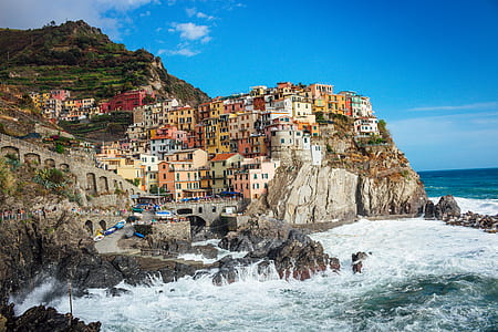 multicolored concrete house near beach during daytime photo thumbnail