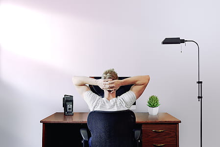 person sitting black swivel chair thumbnail