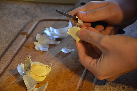 person peeling garlic thumbnail