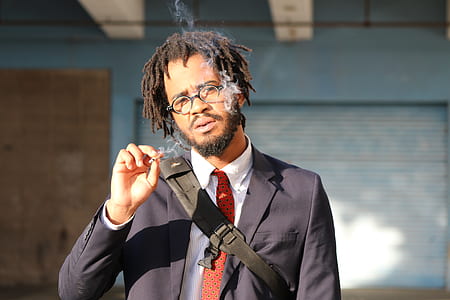 shallow focus photography of man smoking cigarette thumbnail