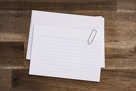 white index card on brown parquet surface thumbnail