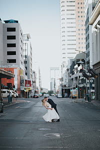 man and woman kissing in the middle of road thumbnail