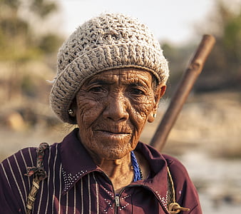 selective focus photography of woman wearing red collared top and white knit cap thumbnail