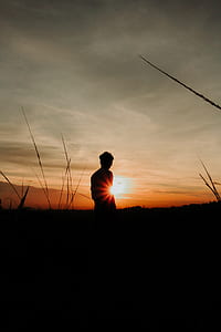 man standing on grass field thumbnail