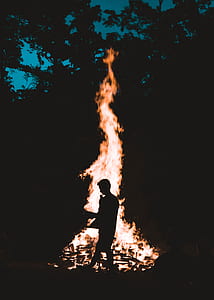 man standing in front of bonfire thumbnail