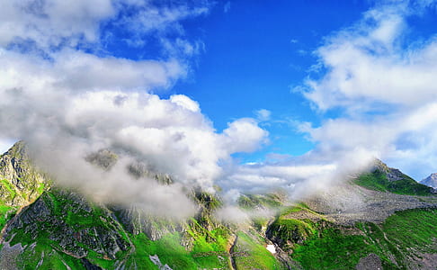 green and gray mountains covered with clouds thumbnail