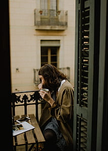 woman sitting on balcony drinking coffee thumbnail