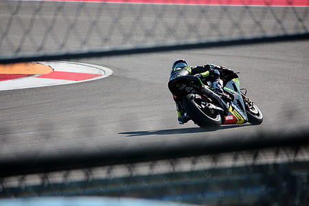 man riding on sports bike on race track during daytime thumbnail