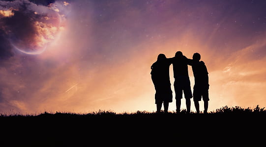 silhouette photo of three people standing during golden hour thumbnail